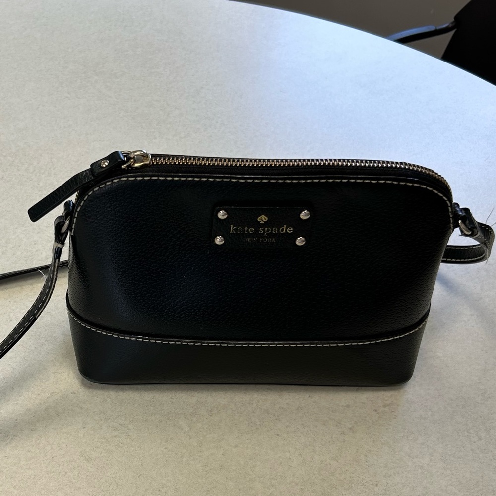 Kate spade black leather crossbody purse with pink lining.